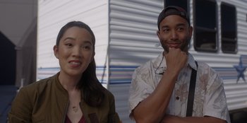 Movie still from “A Hollywood Christmas” (2022), directed by Alex Ranarivelo – A man and a woman posing for a picture; Medium shot, Over the shoulder angle