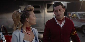 Movie still from “A Hollywood Christmas” (2022), directed by Alex Ranarivelo – A man and a woman with fake blood on their necks; Close Up shot, Over the shoulder angle