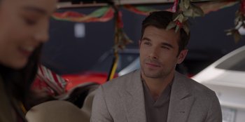 Movie still from “A Hollywood Christmas” (2022), directed by Alex Ranarivelo – A person wearing a suit; Close Up shot, Over the shoulder angle