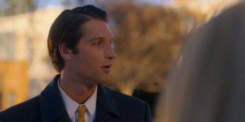 Movie still from “A Hollywood Christmas” (2022), directed by Alex Ranarivelo – A man in a suit and tie looking to his left; Close Up shot, Over the shoulder angle