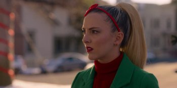 Movie still from “A Hollywood Christmas” (2022), directed by Alex Ranarivelo – A woman with a red bow in her hair; Close Up shot, Over the shoulder angle