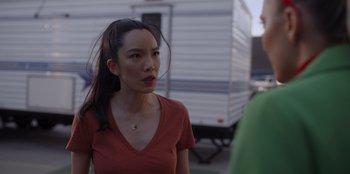 Movie still from “A Hollywood Christmas” (2022), directed by Alex Ranarivelo – A woman standing next to a camper trailer; Close Up shot, Over the shoulder angle