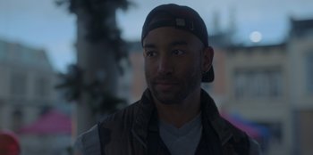 Movie still from “A Hollywood Christmas” (2022), directed by Alex Ranarivelo – A person wearing a hat; Close Up shot, Low angle