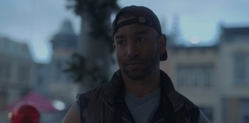 Movie still from “A Hollywood Christmas” (2022), directed by Alex Ranarivelo – A person wearing a cap; Close Up shot, Over the shoulder angle