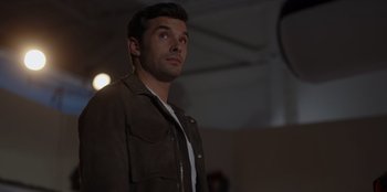 Movie still from “A Hollywood Christmas” (2022), directed by Alex Ranarivelo – A man standing in the dark looking up at the sky; Close Up shot, Low angle