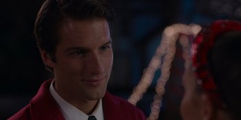 Movie still from “A Hollywood Christmas” (2022), directed by Alex Ranarivelo – A man in a red jacket is smiling at the camera; Close Up shot, Over the shoulder angle