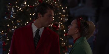 Movie still from “A Hollywood Christmas” (2022), directed by Alex Ranarivelo – A man in a red jacket and a woman in a green suit; Close Up shot, Over the shoulder angle