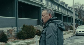 Movie still from “A Man Called Otto” (2022), directed by Marc Forster – A man wearing a jacket and a hood is walking down the street; Close Up shot, Low angle