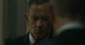 Movie still from “A Man Called Otto” (2022), directed by Marc Forster – A person wearing a suit and tie; Close Up shot, Over the shoulder angle