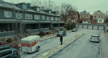 Movie still from “A Man Called Otto” (2022), directed by Marc Forster – A man standing on the side of the road next to cars; Extreme Wide shot, High angle