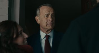 Movie still from “A Man Called Otto” (2022), directed by Marc Forster – An older man wearing a suit and tie; Close Up shot, Over the shoulder angle