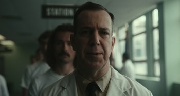 Movie still from “A Man Called Otto” (2022), directed by Marc Forster – A person wearing a white lab coat; Close Up shot, Low angle