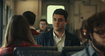 Movie still from “A Man Called Otto” (2022), directed by Marc Forster – A man sitting on a train looking at something; Medium shot, Over the shoulder angle