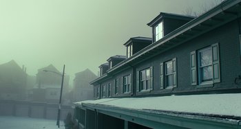 Movie still from “A Man Called Otto” (2022), directed by Marc Forster – A row of windows on the side of a building in the snow; Extreme Wide shot, Low angle