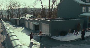 Movie still from “A Man Called Otto” (2022), directed by Marc Forster – Two people are carrying a ladder in the snow; Extreme Wide shot, High angle