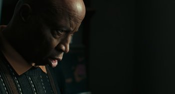 Movie still from “A Man Called Otto” (2022), directed by Marc Forster – A man with a bald head looking to his left; Close Up shot, Low angle