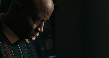 Movie still from “A Man Called Otto” (2022), directed by Marc Forster – A man with a bald head is looking down; Close Up shot, Low angle