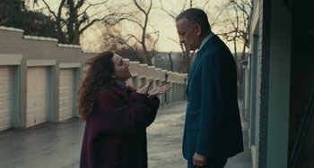 Movie still from “A Man Called Otto” (2022), directed by Marc Forster – A woman and a man standing next to each other on a sidewalk; Medium shot, Over the shoulder angle
