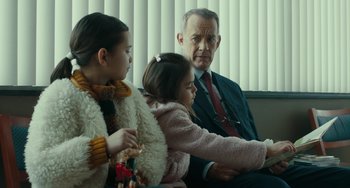 Movie still from “A Man Called Otto” (2022), directed by Marc Forster – Two girls and an older man sitting on a couch; Medium shot, Low angle