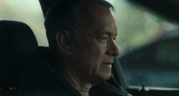 Movie still from “A Man Called Otto” (2022), directed by Marc Forster – An older man sitting in a car looking out the window; Close Up shot, Over the shoulder angle