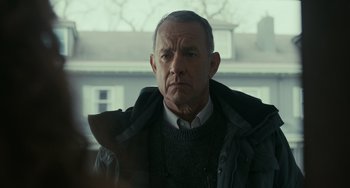Movie still from “A Man Called Otto” (2022), directed by Marc Forster – An older man wearing a sweater and a jacket; Close Up shot, Over the shoulder angle