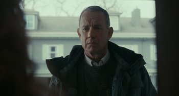 Movie still from “A Man Called Otto” (2022), directed by Marc Forster – An older man wearing a sweater and a jacket; Close Up shot, Over the shoulder angle