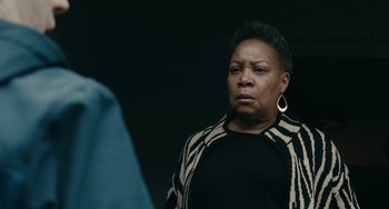 Movie still from “A Man Called Otto” (2022), directed by Marc Forster – An older black woman looking at the camera; Close Up shot, Over the shoulder angle