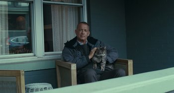 Movie still from “A Man Called Otto” (2022), directed by Marc Forster – A man sitting in a chair holding a cat; Close Up shot, Low angle