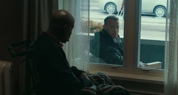 Movie still from “A Man Called Otto” (2022), directed by Marc Forster – A man sitting in front of a window looking at himself in the mirror; Medium shot, Over the shoulder angle