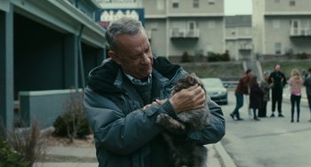 Movie still from “A Man Called Otto” (2022), directed by Marc Forster – An older man holding a cat on a city street; Close Up shot, Over the shoulder angle