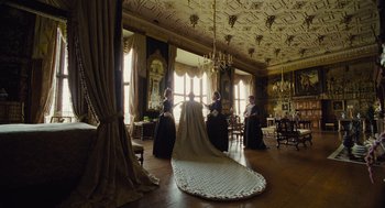 Movie still from “The Favourite” (2018), directed by Yorgos Lanthimos – A group of people in a room with a large rug; Wide shot, Low angle