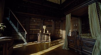 Movie still from “The Favourite” (2018), directed by Yorgos Lanthimos – A room filled with lots of books on a shelf; Extreme Wide shot, High angle