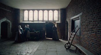 Movie still from “The Favourite” (2018), directed by Yorgos Lanthimos – Two women dressed in period clothing in an old - fashioned building; Wide shot, Low angle