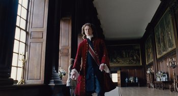 Movie still from “The Favourite” (2018), directed by Yorgos Lanthimos – A man in a red coat and a red sash; Medium shot, Low angle