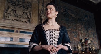 Movie still from “The Favourite” (2018), directed by Yorgos Lanthimos – A woman in a black and white dress holding a ring in her hand; Medium shot, Low angle