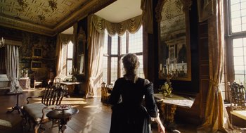 Movie still from “The Favourite” (2018), directed by Yorgos Lanthimos – A woman standing in front of a window in a room; Wide shot, Low angle