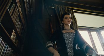 Movie still from “The Favourite” (2018), directed by Yorgos Lanthimos – A woman in a black and white dress standing next to a window; Medium shot, Low angle