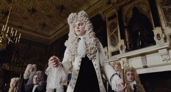 Movie still from “The Favourite” (2018), directed by Yorgos Lanthimos – A man in a white wig and a white coat; Medium shot, Low angle