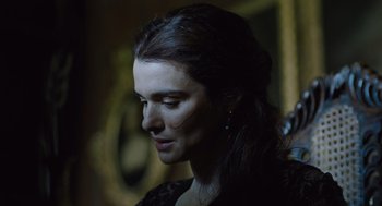 Movie still from “The Favourite” (2018), directed by Yorgos Lanthimos – A person wearing a black dress; Close Up shot, Over the shoulder angle