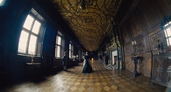 Movie still from “The Favourite” (2018), directed by Yorgos Lanthimos – A man and a woman are standing in a room with checkered floors; Extreme Wide shot, High angle