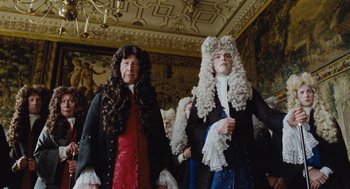 Movie still from “The Favourite” (2018), directed by Yorgos Lanthimos – Two people in period costumes and wigs standing in a room; Medium shot, Over the shoulder angle