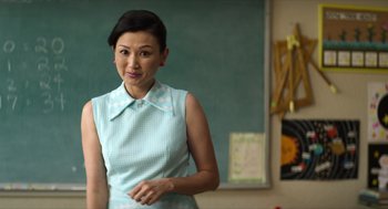 Movie still from “A Million Miles Away” (2023), directed by Alejandra Márquez Abella – A woman standing in front of a chalkboard in a classroom; Medium shot, Over the shoulder angle