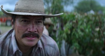 Movie still from “A Million Miles Away” (2023), directed by Alejandra Márquez Abella – A person wearing a cowboy hat; Close Up shot, Over the shoulder angle
