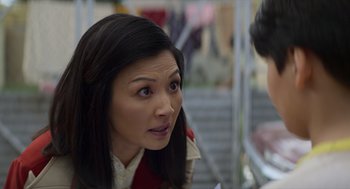 Movie still from “A Million Miles Away” (2023), directed by Alejandra Márquez Abella – A person with long black hair; Close Up shot, Over the shoulder angle