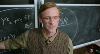 Movie still from “A Million Miles Away” (2023), directed by Alejandra Márquez Abella – A man in a brown sweater and glasses; Medium shot, Over the shoulder angle
