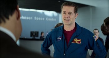 Movie still from “A Million Miles Away” (2023), directed by Alejandra Márquez Abella – A man in a blue suit standing next to a building; Close Up shot, Over the shoulder angle