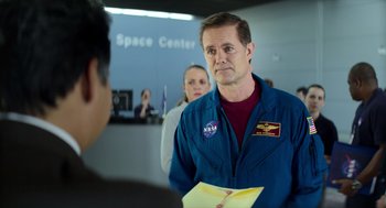 Movie still from “A Million Miles Away” (2023), directed by Alejandra Márquez Abella – A man in a space suit is looking at a woman; Medium shot, Over the shoulder angle