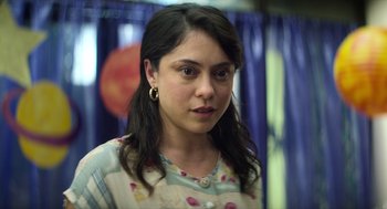 Movie still from “A Million Miles Away” (2023), directed by Alejandra Márquez Abella – A person wearing a dress; Close Up shot, Over the shoulder angle