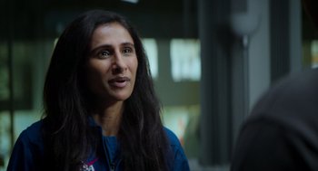 Movie still from “A Million Miles Away” (2023), directed by Alejandra Márquez Abella – A woman with long black hair is looking at the camera; Close Up shot, Over the shoulder angle