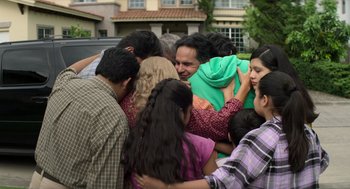 Movie still from “A Million Miles Away” (2023), directed by Alejandra Márquez Abella – A group of people standing around each other in the street; Medium shot, Over the shoulder angle